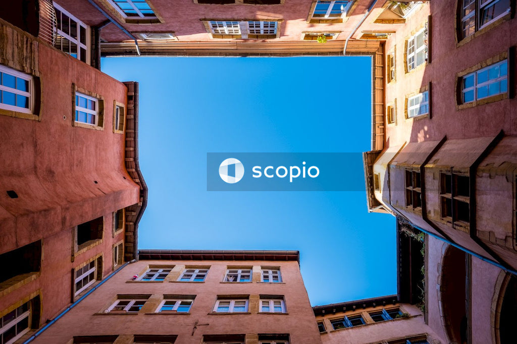Photo of Sky View From Courtyard Surrounded by Colorful Buildings