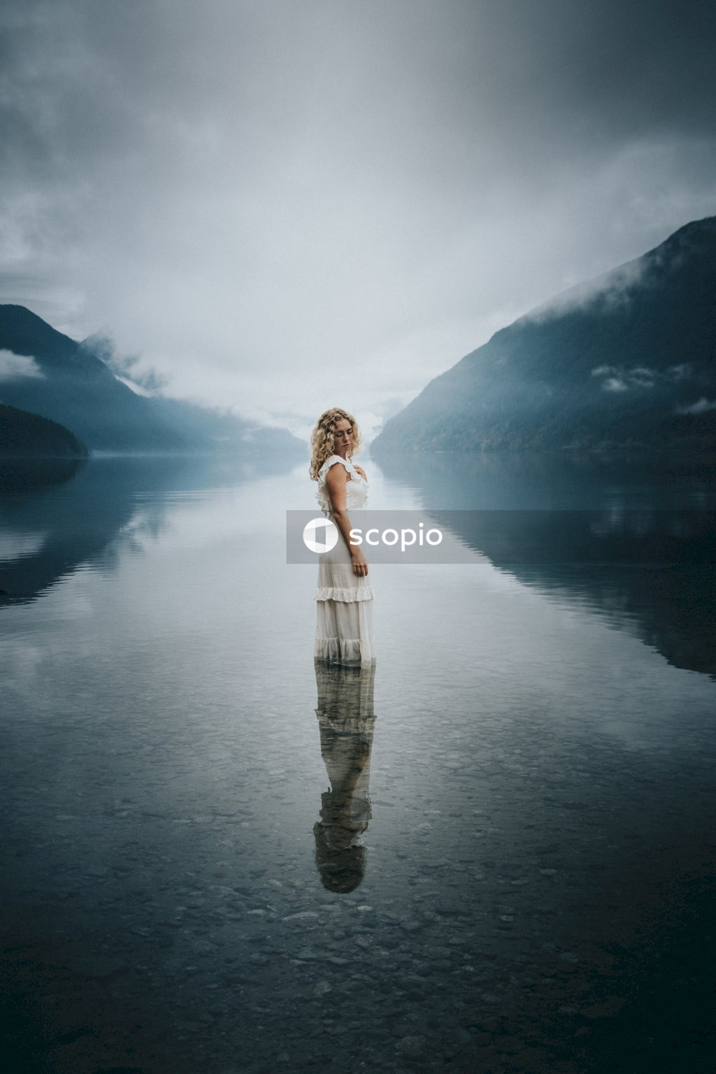 Woman in white dress standing on water