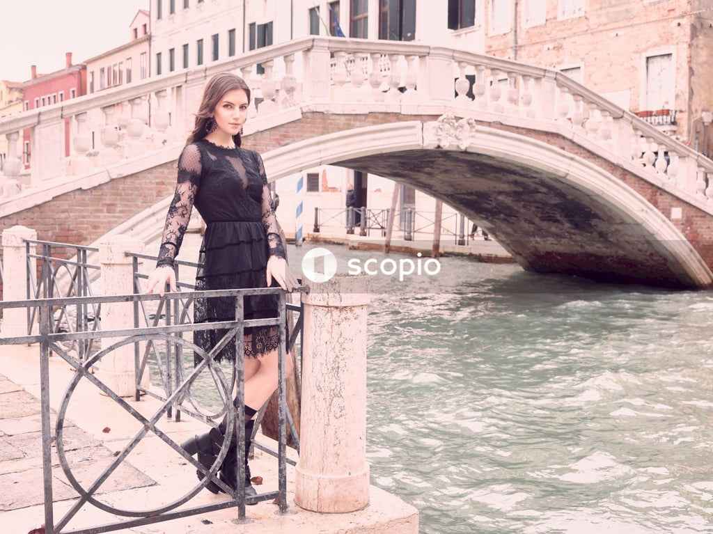 Woman standing beside realto bridge, italy