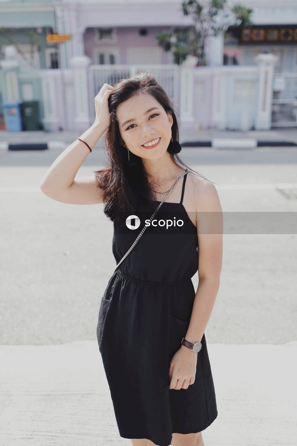 Woman on street posing near building