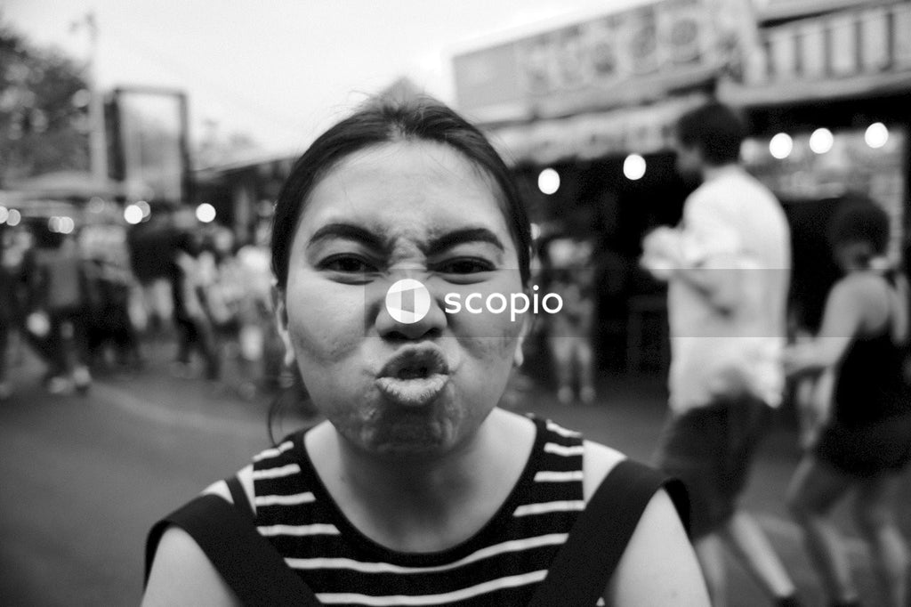 Grayscale photo of woman in black and white stripe shirt