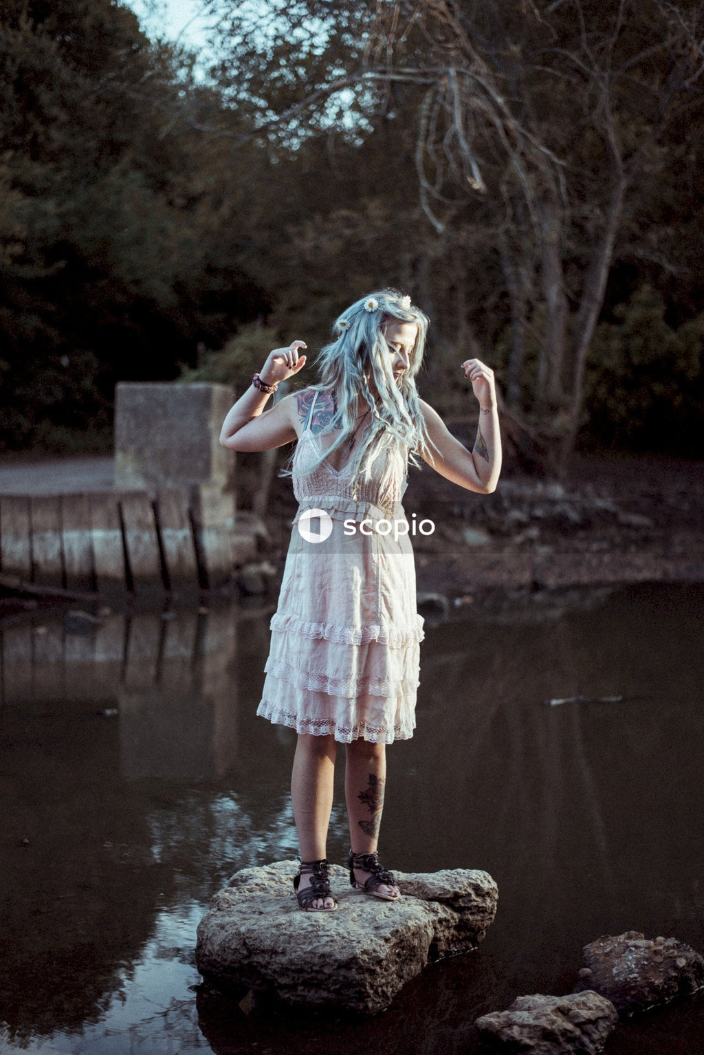 Woman in white and red dress standing on water