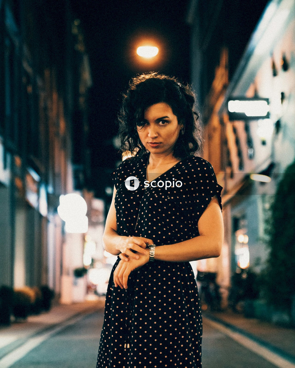 Woman touching her watch in the middle of the road