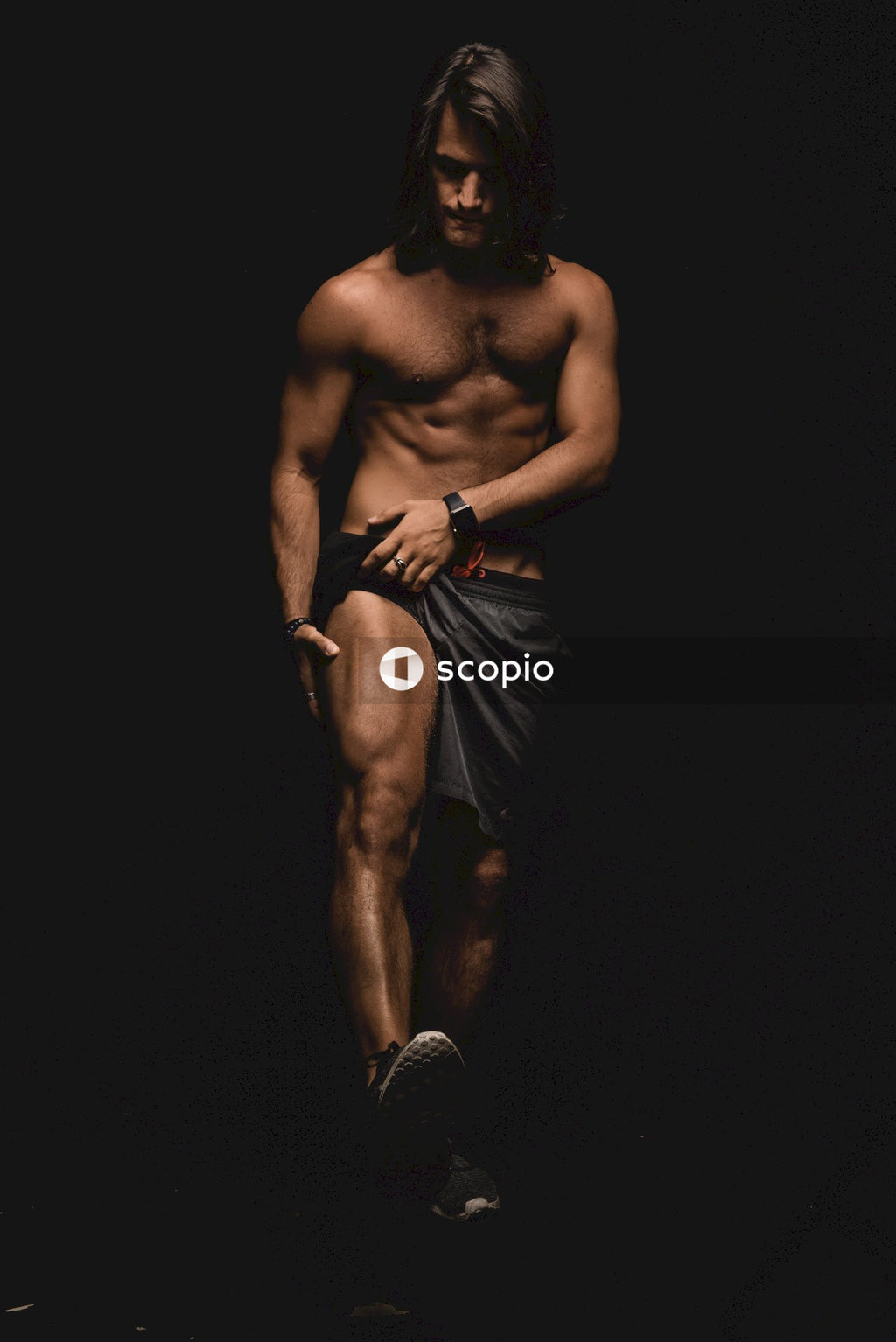 Topless man showing a muscular leg