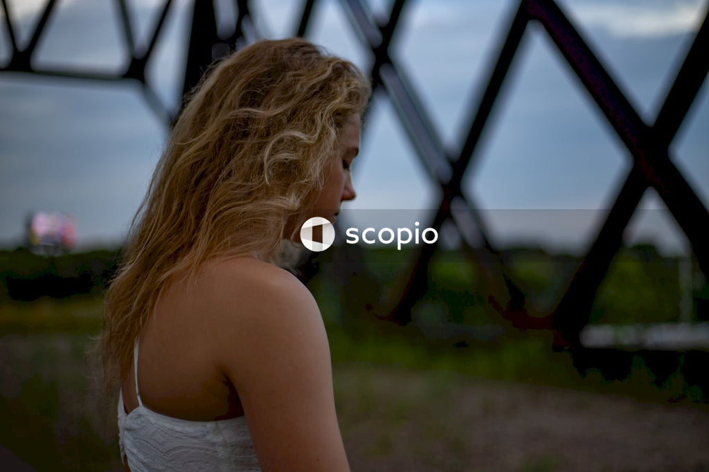 Side view of sad young woman standing outdoor