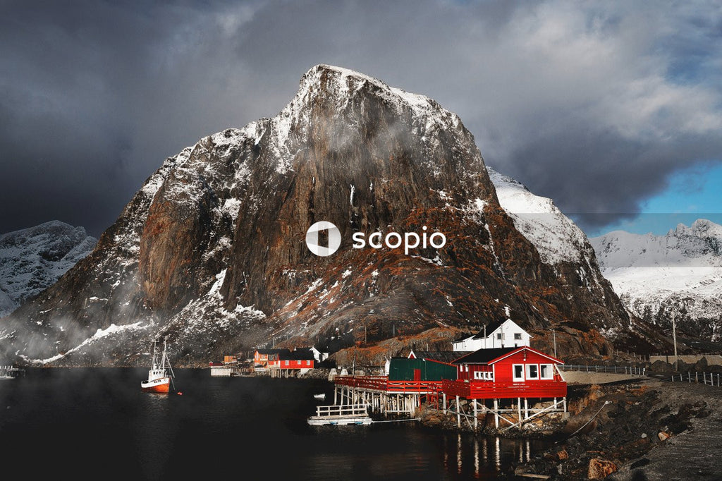 Red and white house near mountain