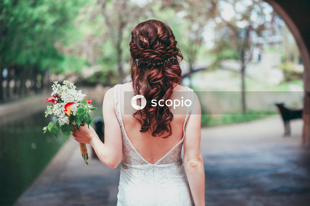 Bride in White Dress Holding Bouquet