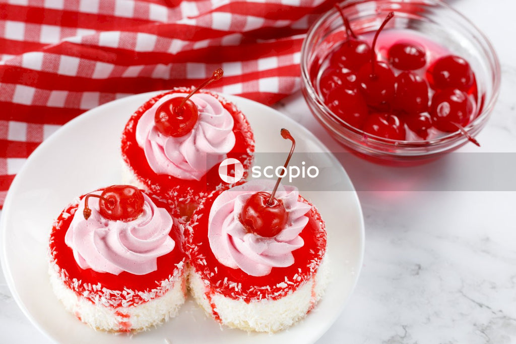3 red and white cupcakes on white ceramic plate
