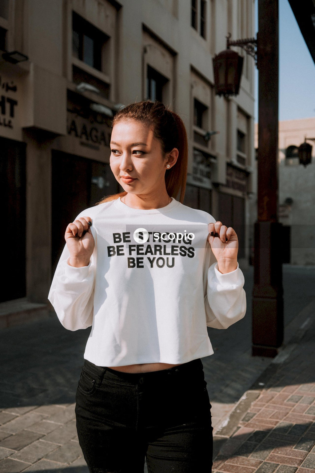 Woman with shirt saying be strong be fearless be you and black pants
