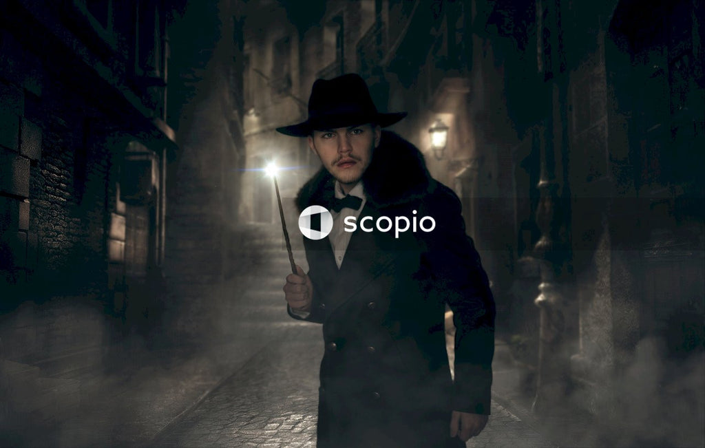 Man in black hat and coat holding wand