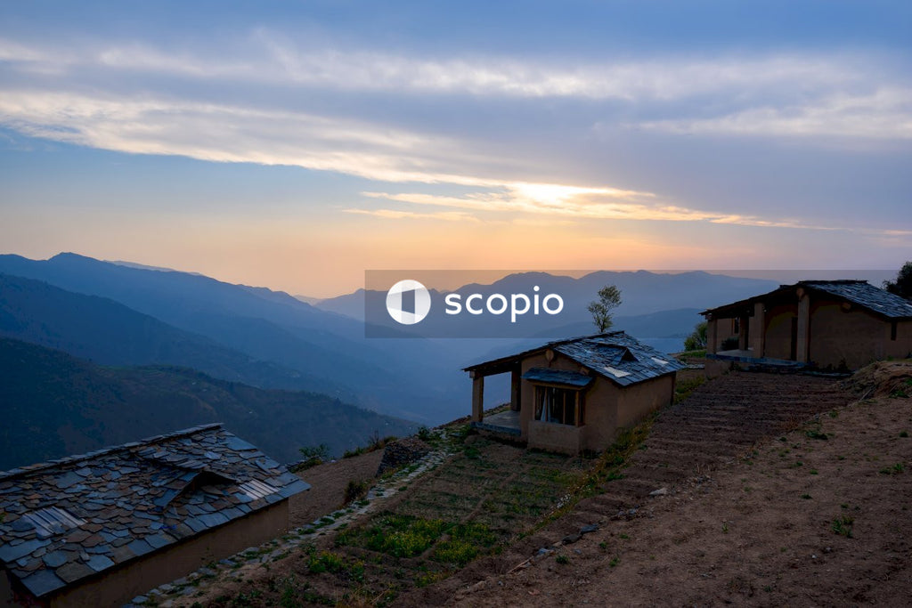 Golden Sunrise Over Mountains Illuminates Traditional Houses on Hillside