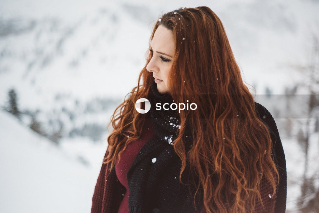 Woman in red knit sweater standing on snow covered ground