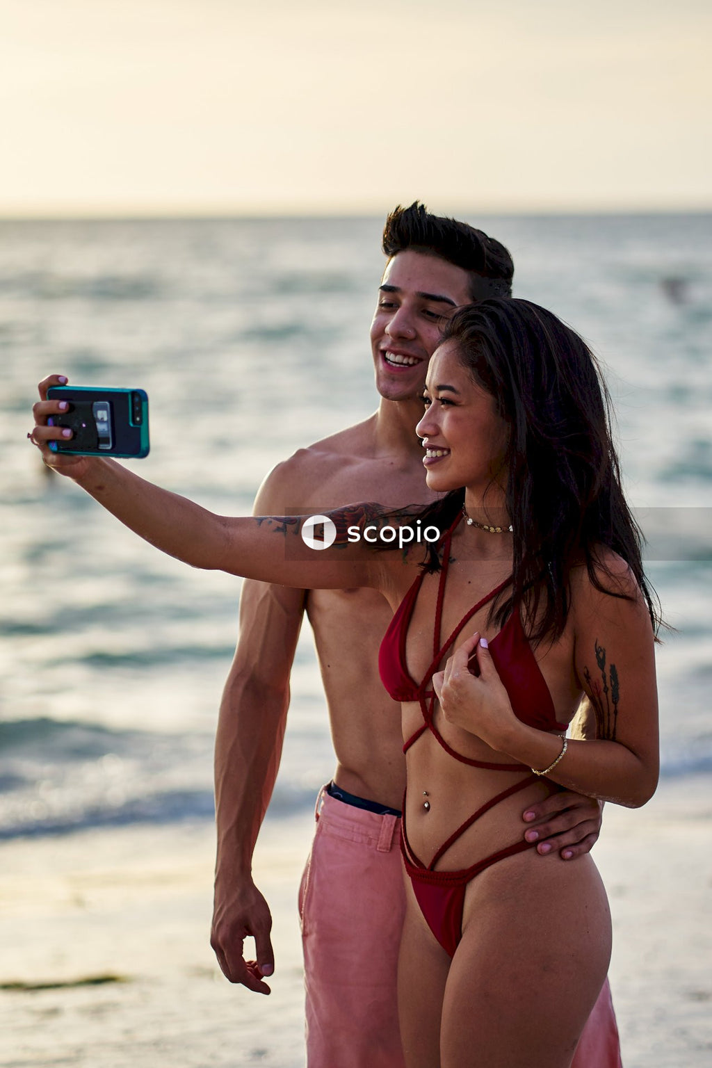 Couple in swimsuits taking selfie
