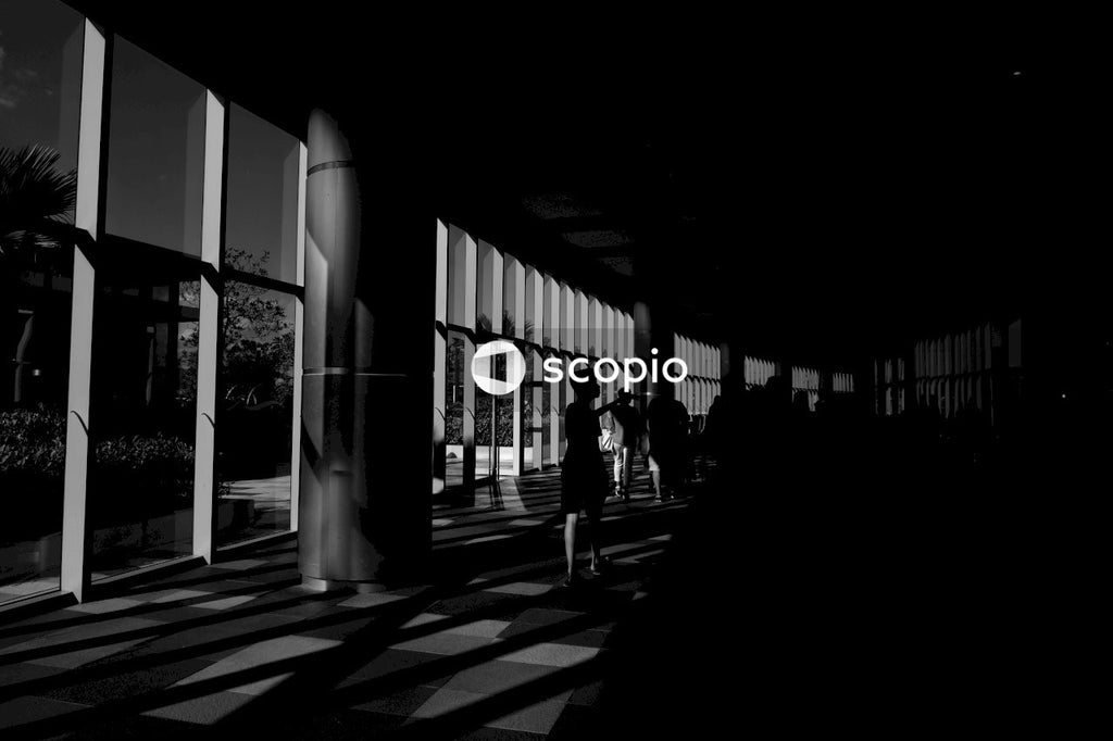 Grayscale photo of people walking on sidewalk