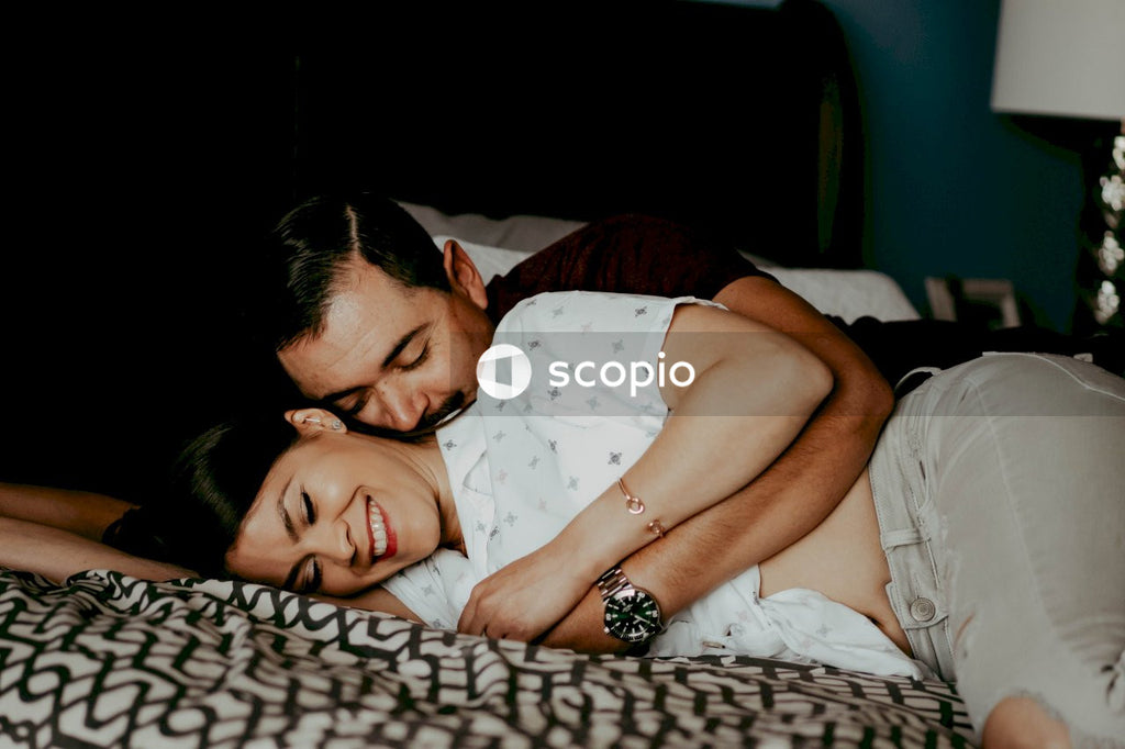 Man in white shirt hugging woman in white shirt