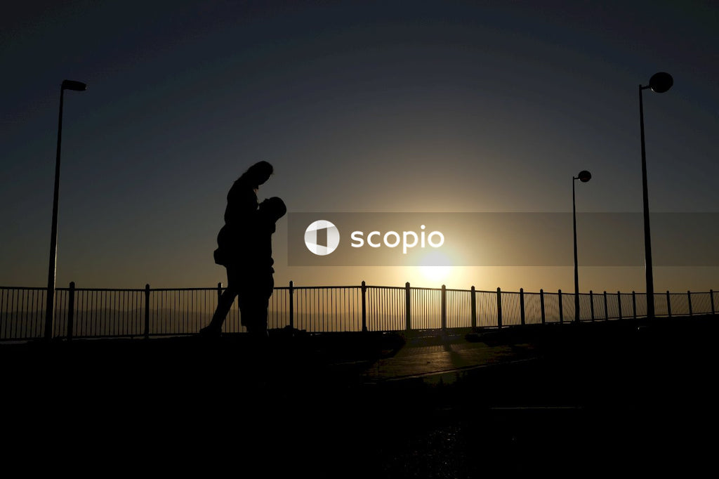 Silhouette of person standing on road during sunset