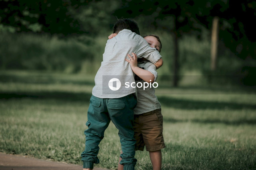 Two siblings hug each other at the park