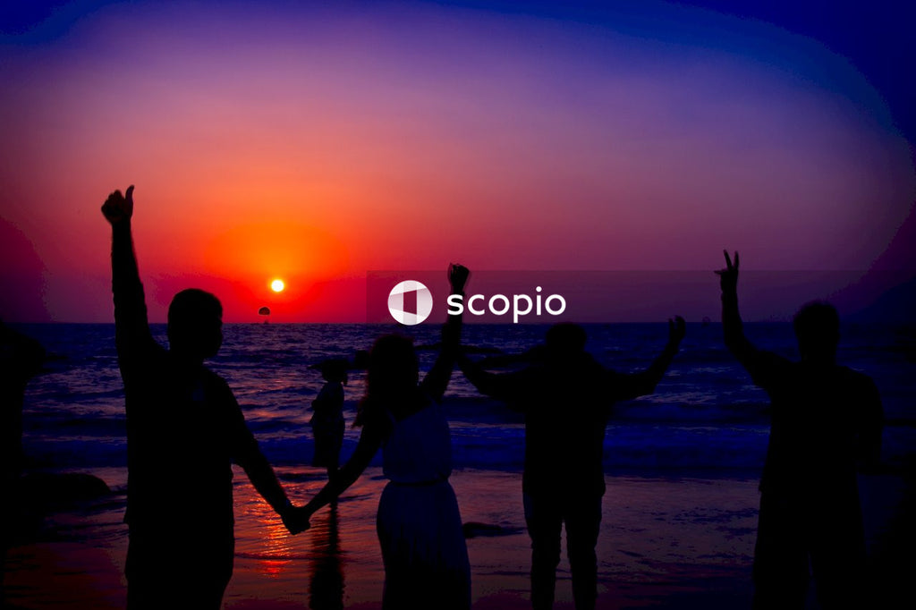 Silhouette of people standing on beach during sunset