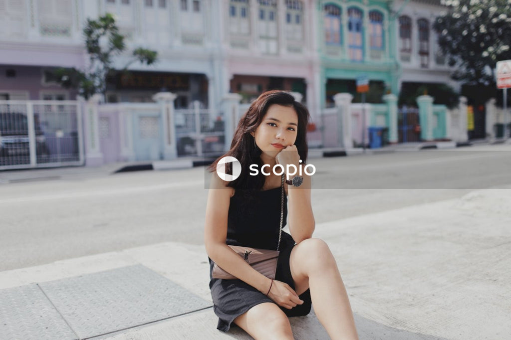 Woman on street posing near building