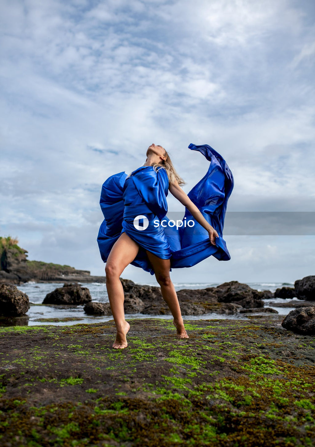 Woman in blue dress standing on grass