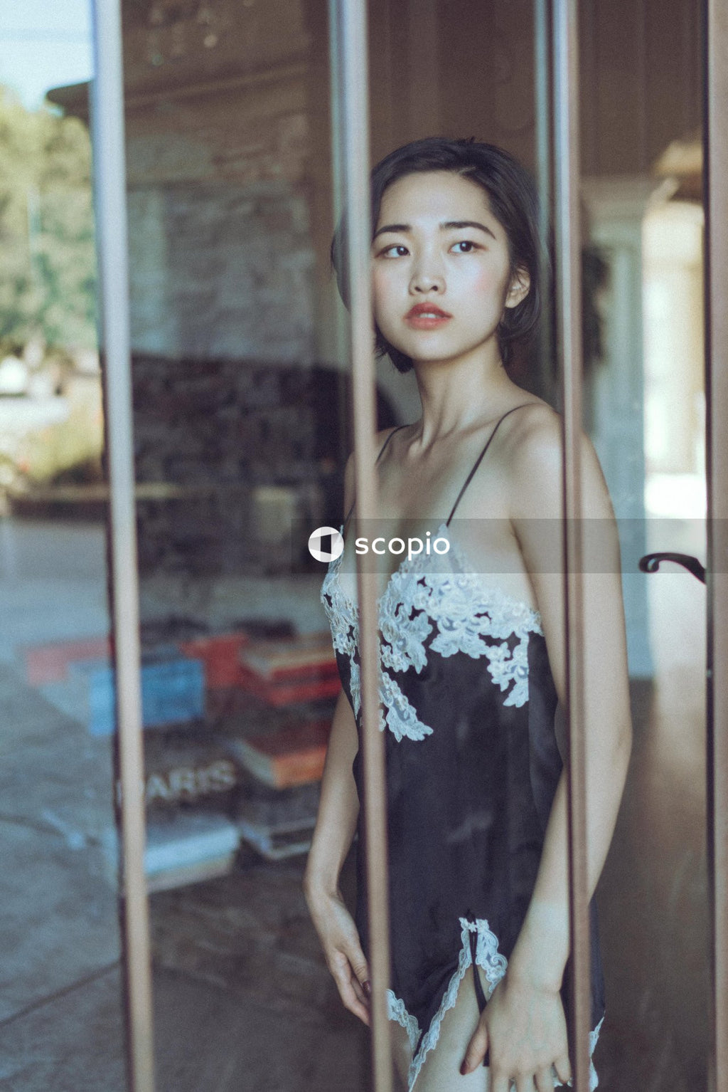 Woman in sexy sleeping gown standing beside window