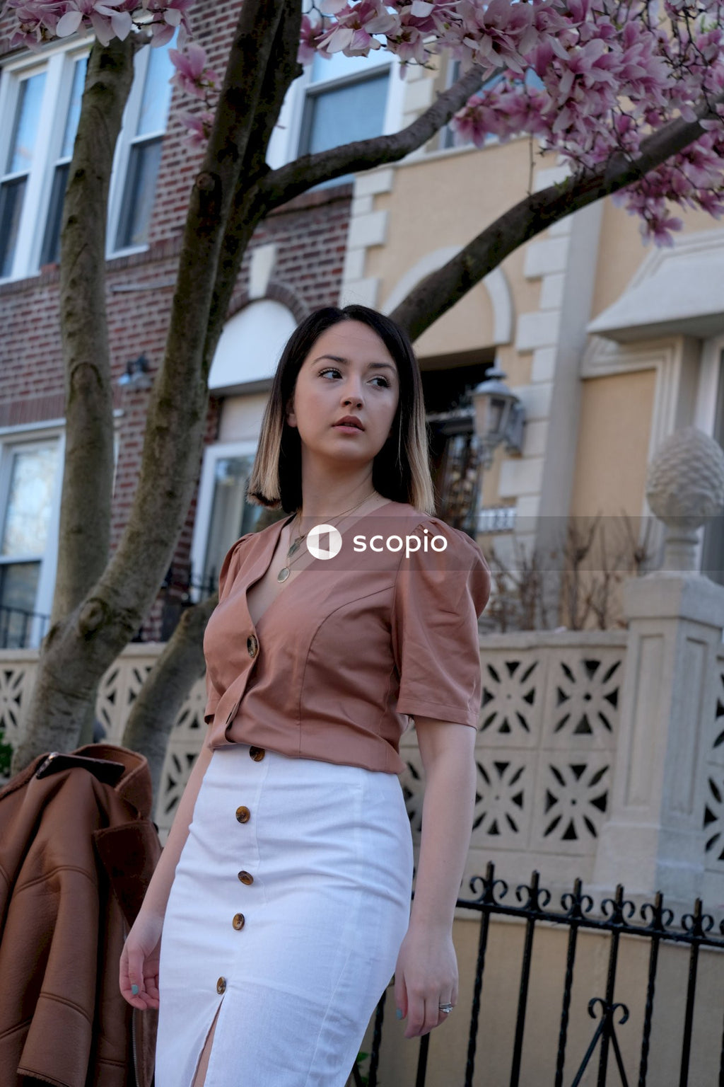 Woman in light skirt and pink shirt