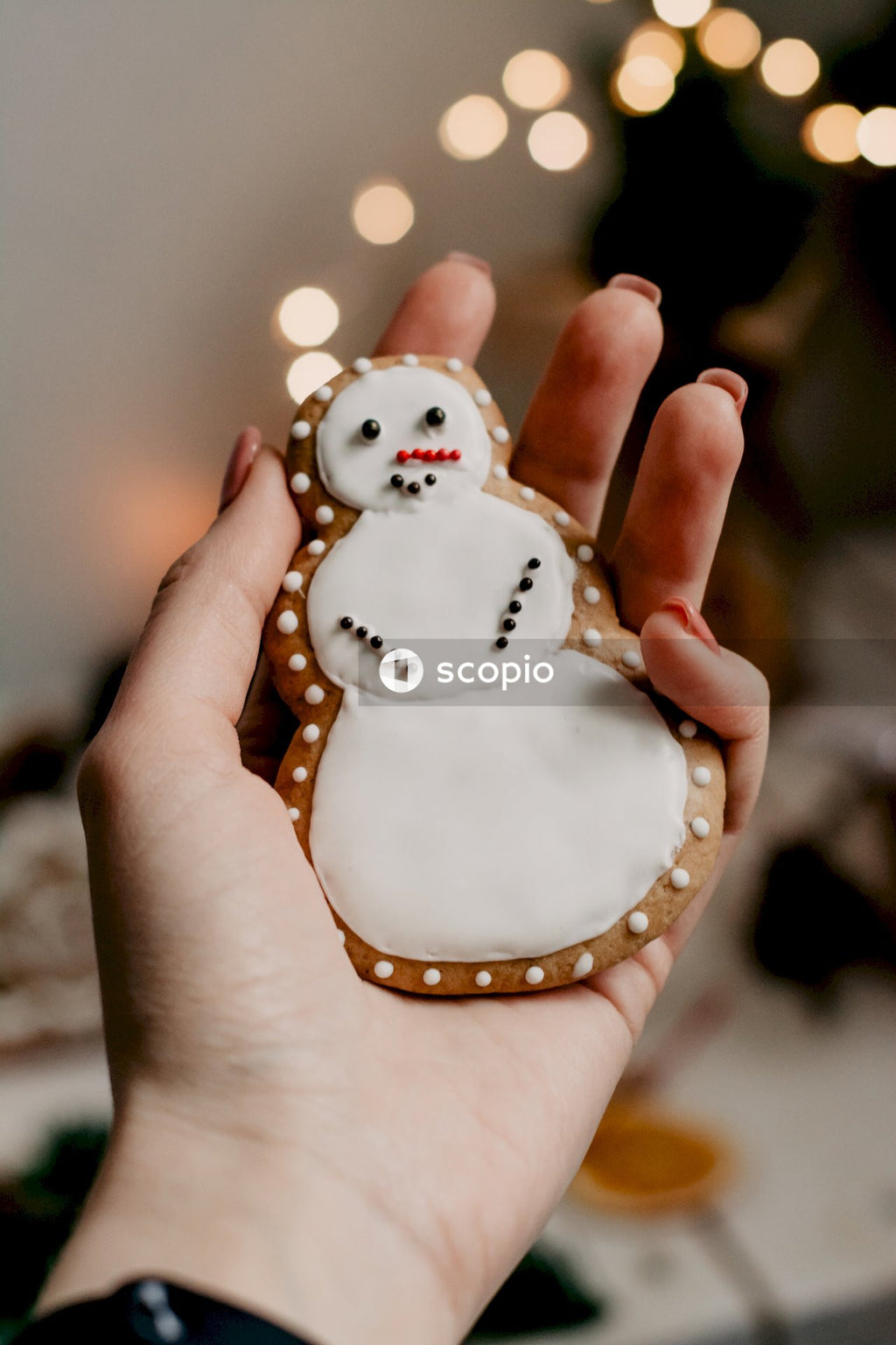 Person holding white snowman ornament