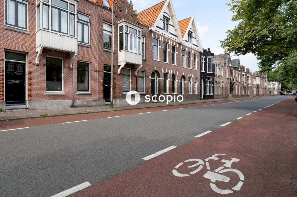 Brown brick houses near asphalt road