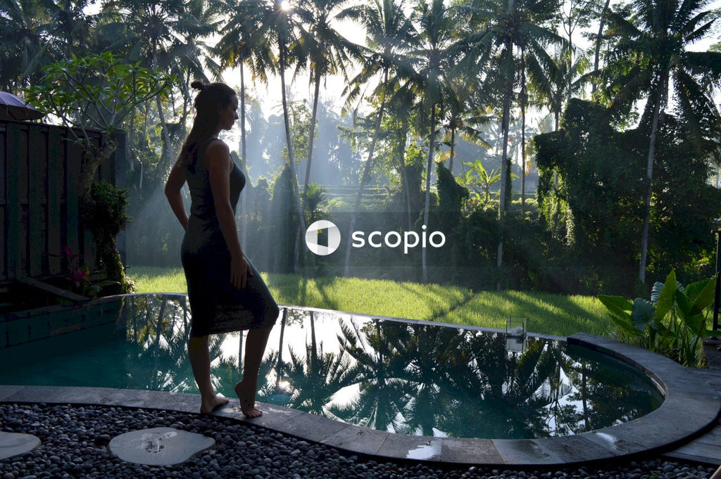 Woman standing next to pool admiring view