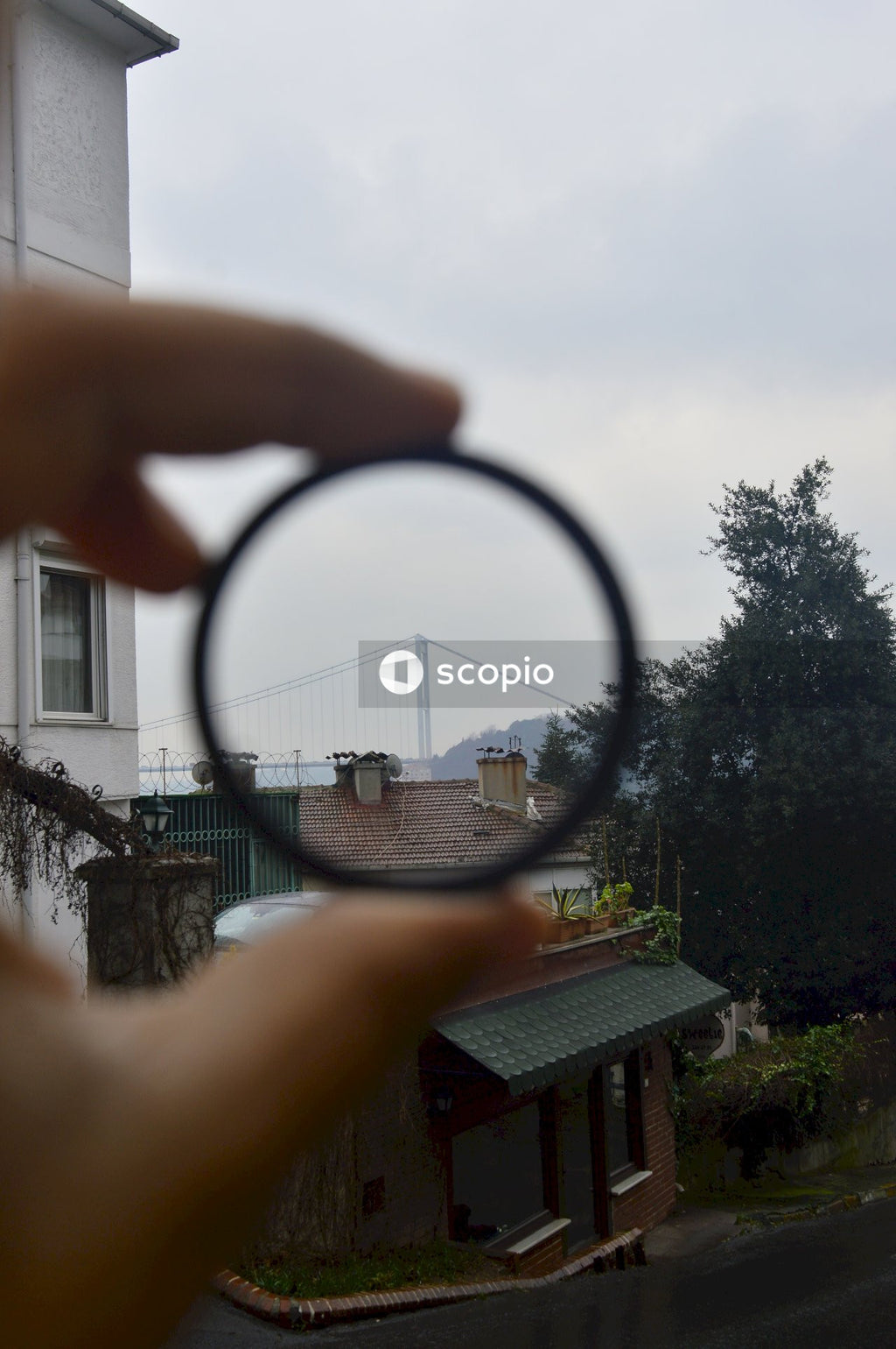 Person holding black magnifying glass