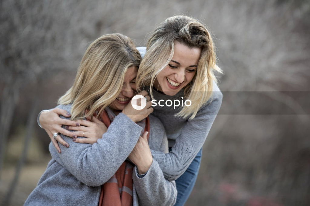 Woman hugging another woman from behind