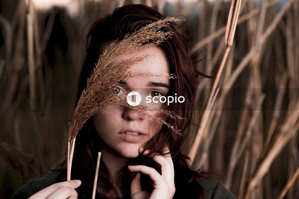 Woman in black long sleeve shirt holding her face