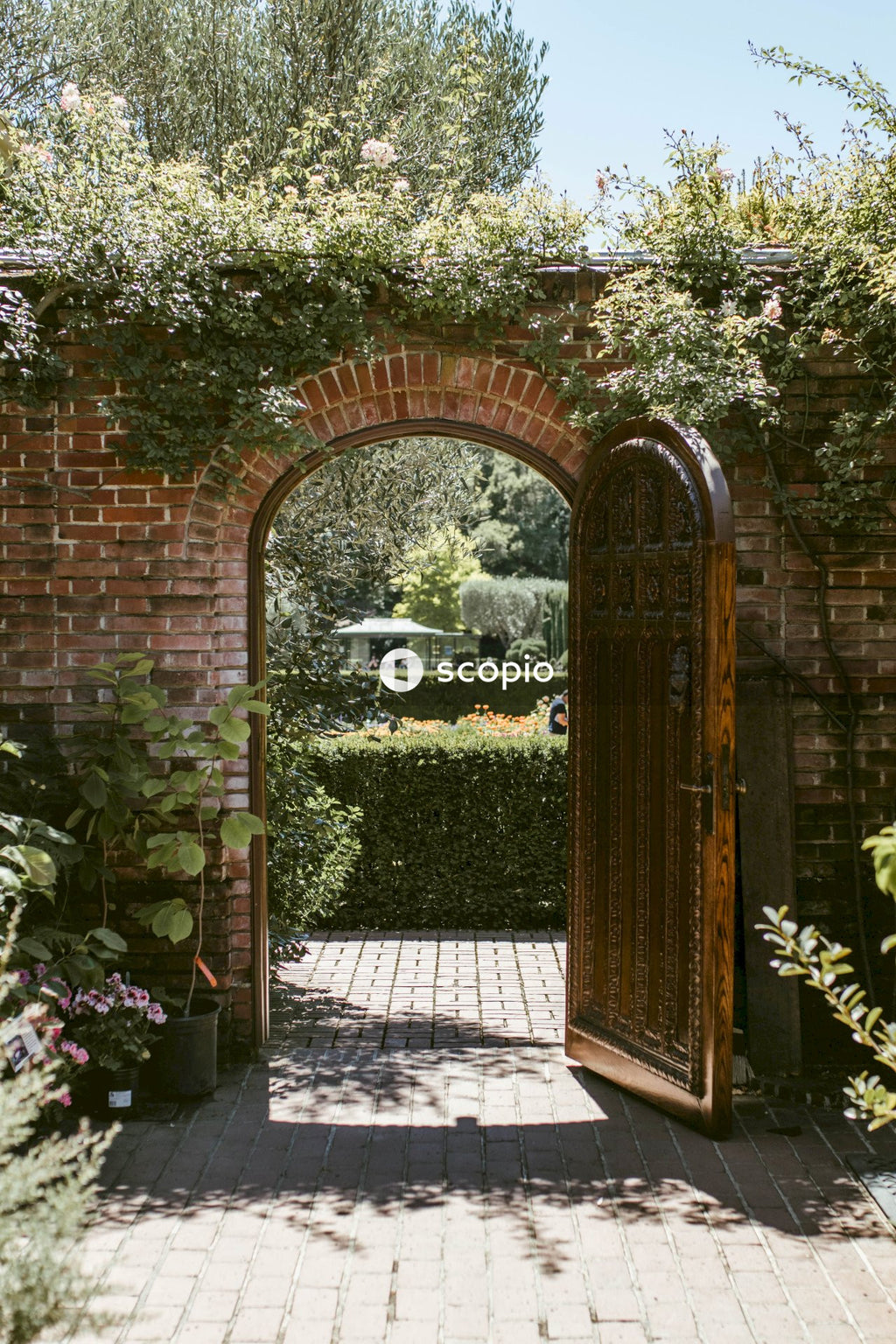 Brown brick arch with green plants