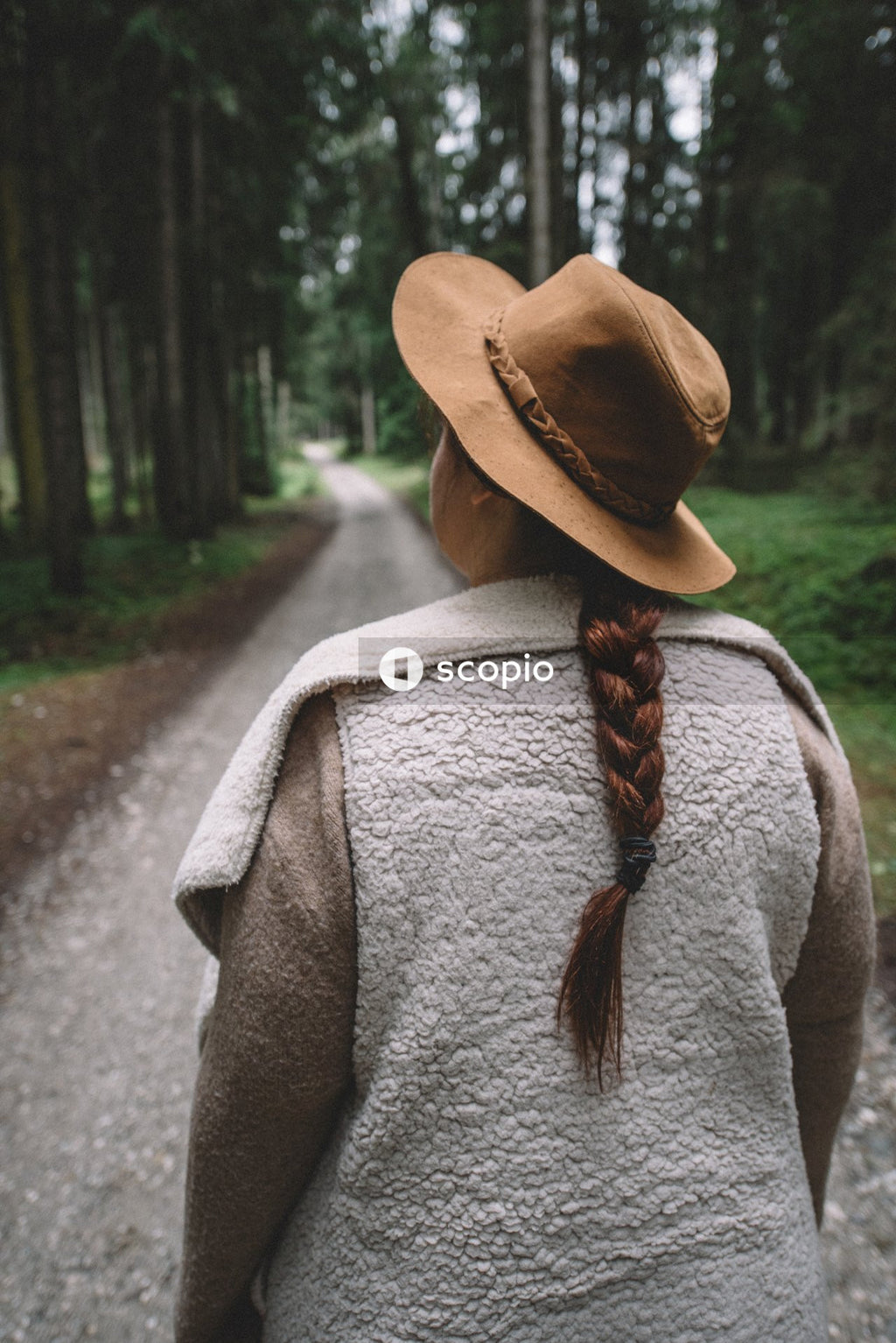 Woman walking on woods looking up