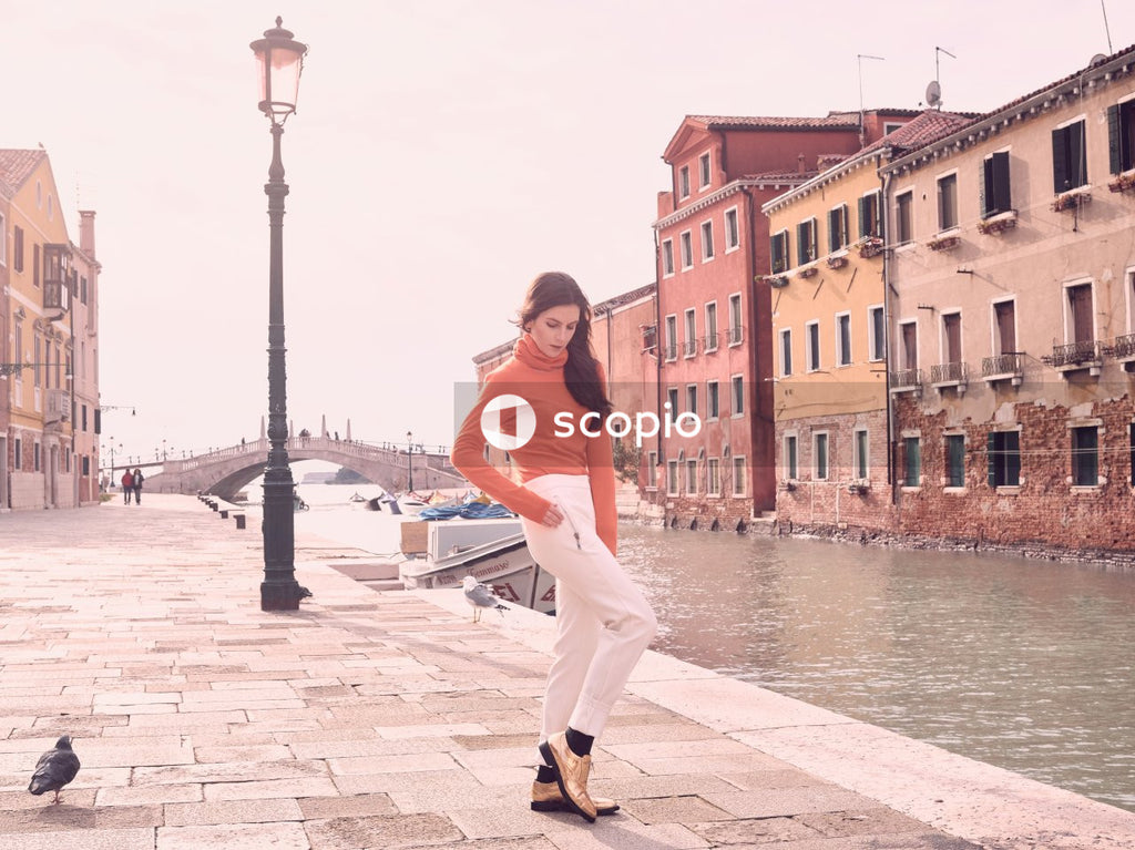 Woman in blue pants near canal