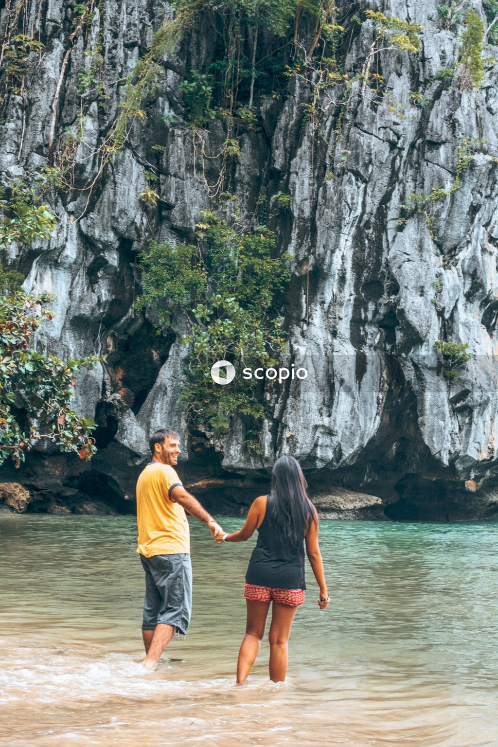 Man and woman holding hands on calm water at daytime