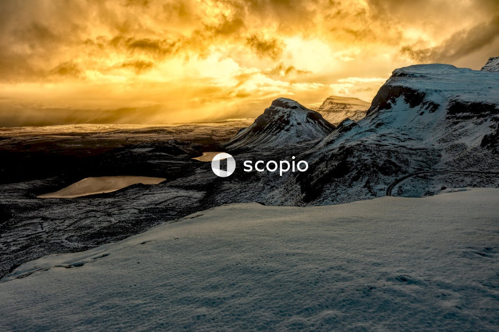 Snow covered mountain under cloudy sky