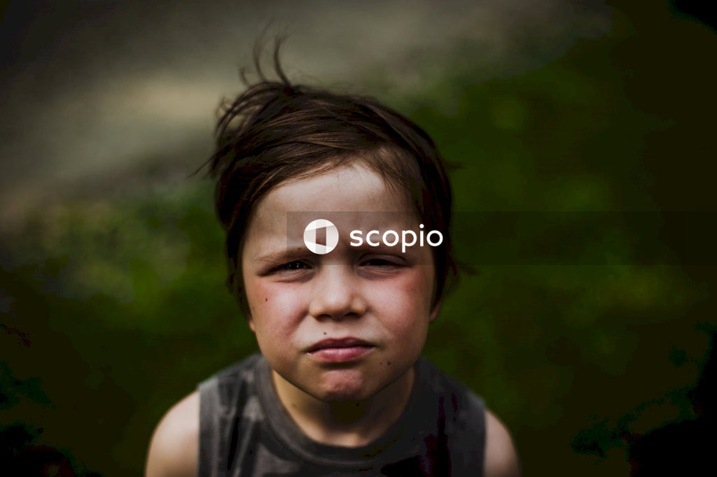 Close-up photo of in focus little boy with face expression