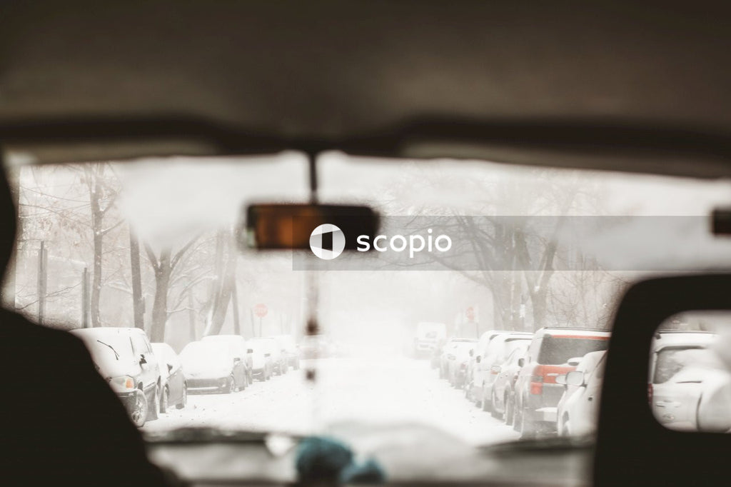 Interior shot of car while person driving on snow covered road