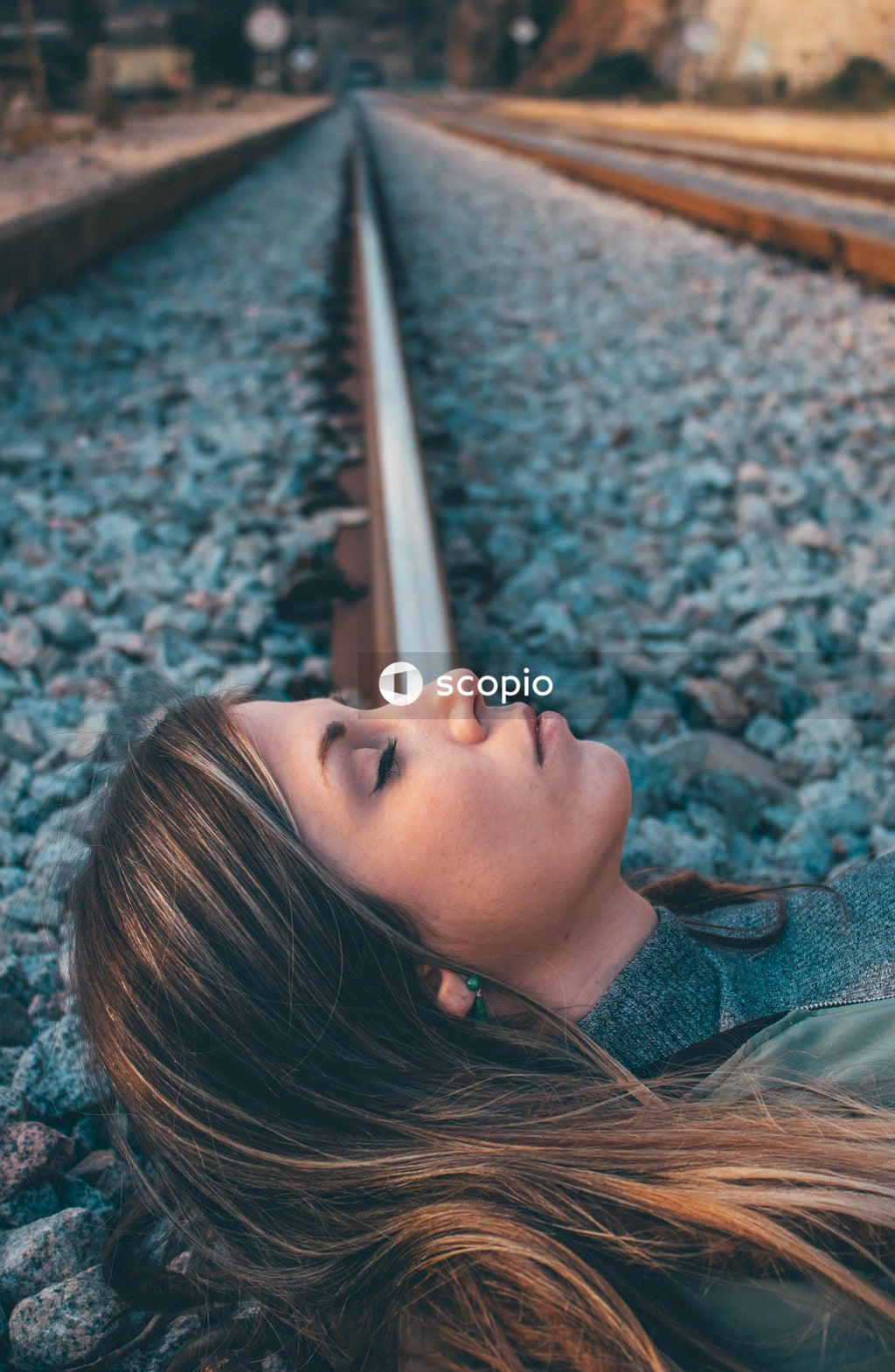 Woman lying on train rail