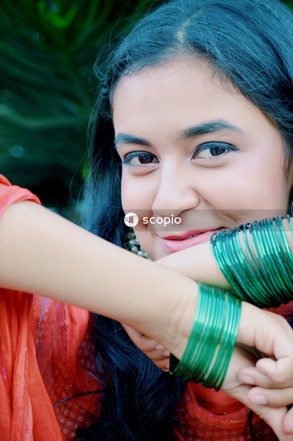 Woman in red shirt with green and blue hair
