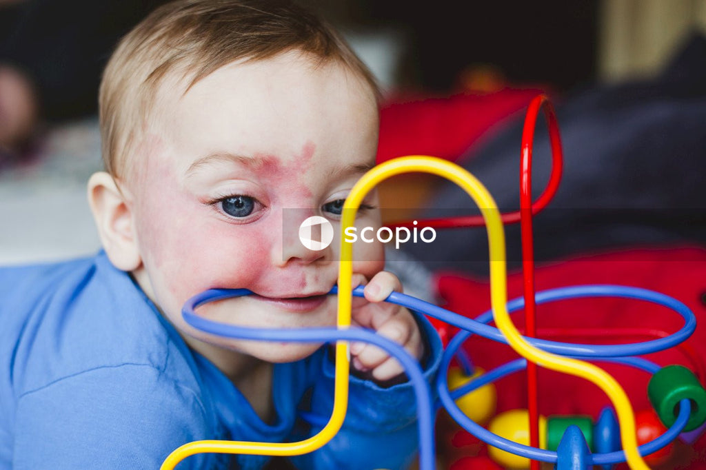 Baby biting on colorful toy