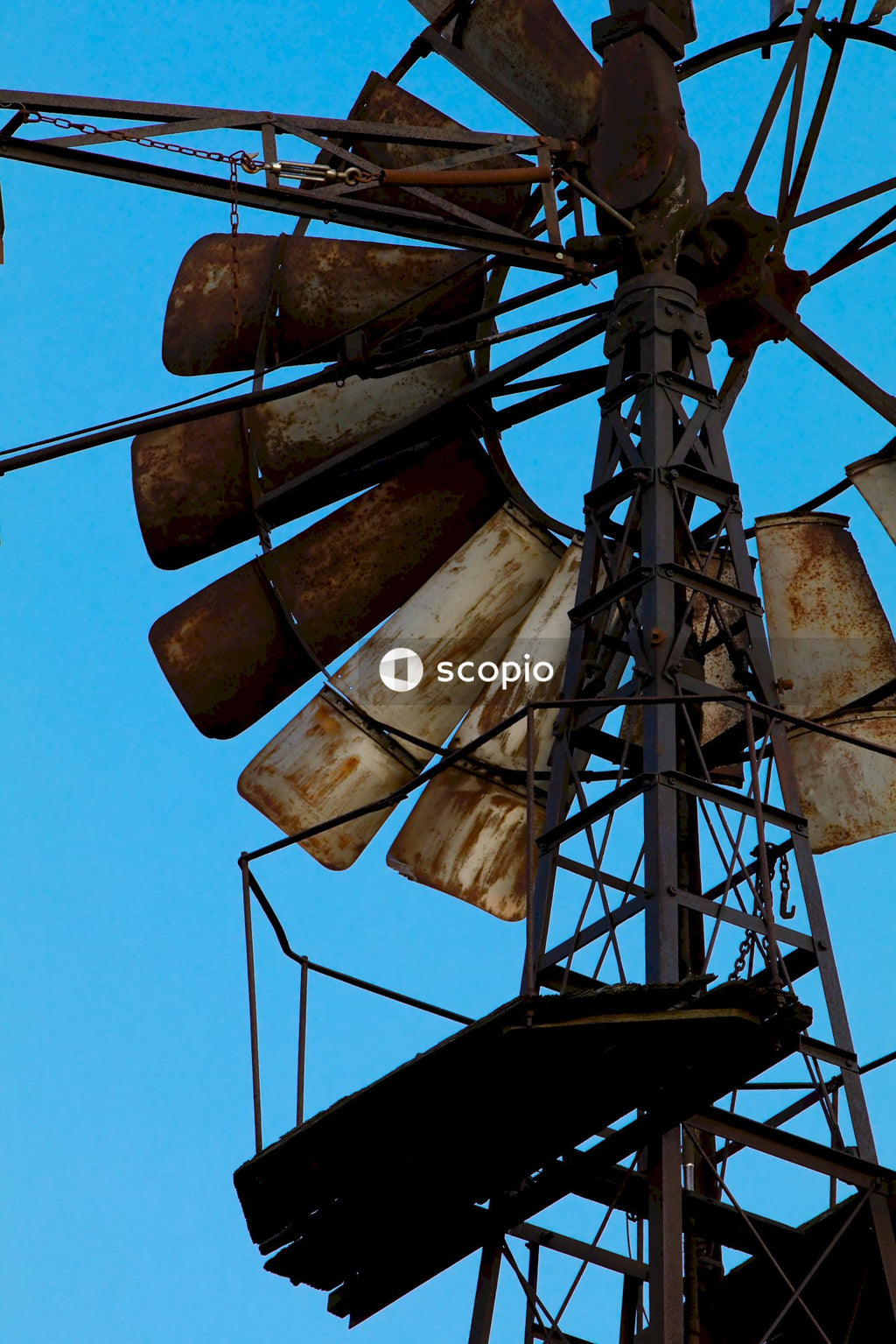 Brown and black wind mill under blue sky