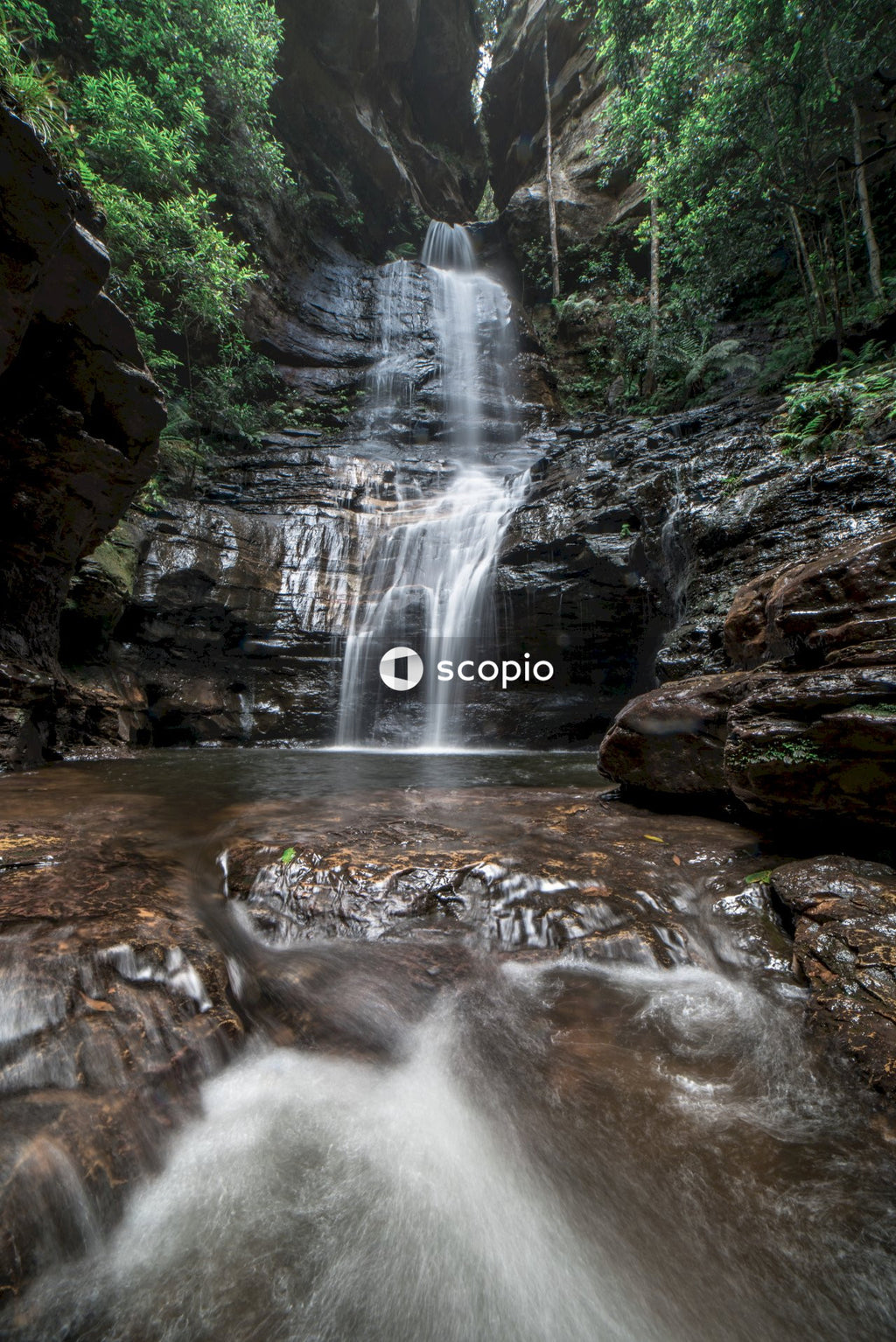 Water falls in the middle of rocky mountain