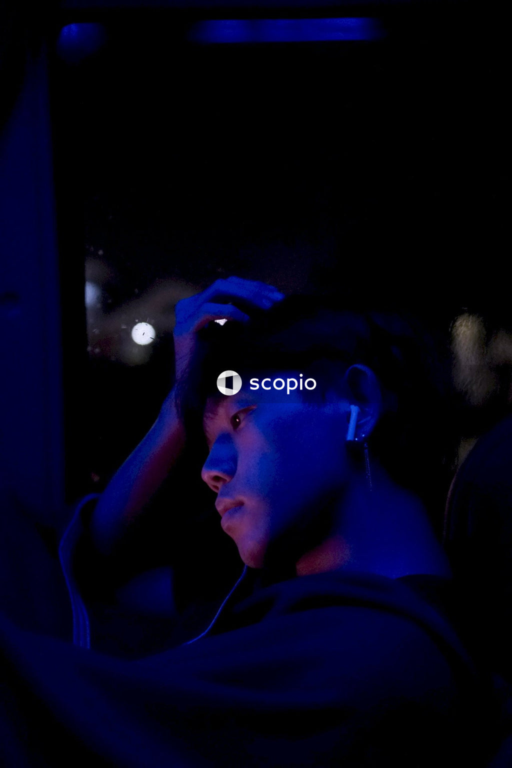 Portrait photoshoot of man standing in blue light