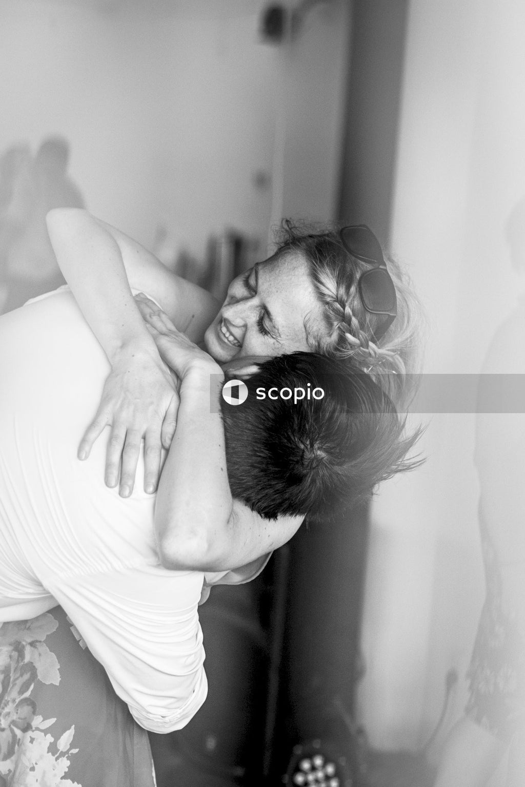 Man in white tank top hugging woman in white tank top