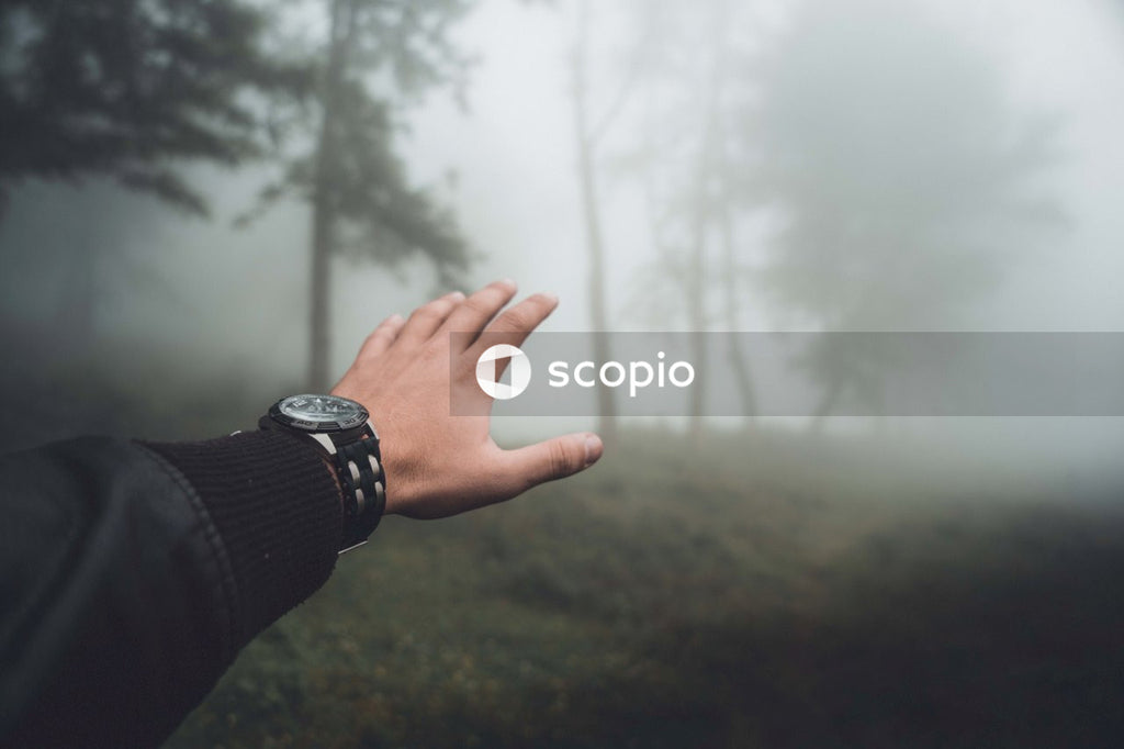 Cropped image of man's hand wearing watch raising right hand