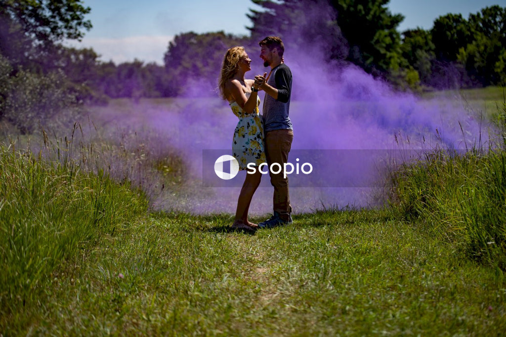 Couple kissing on green grass field