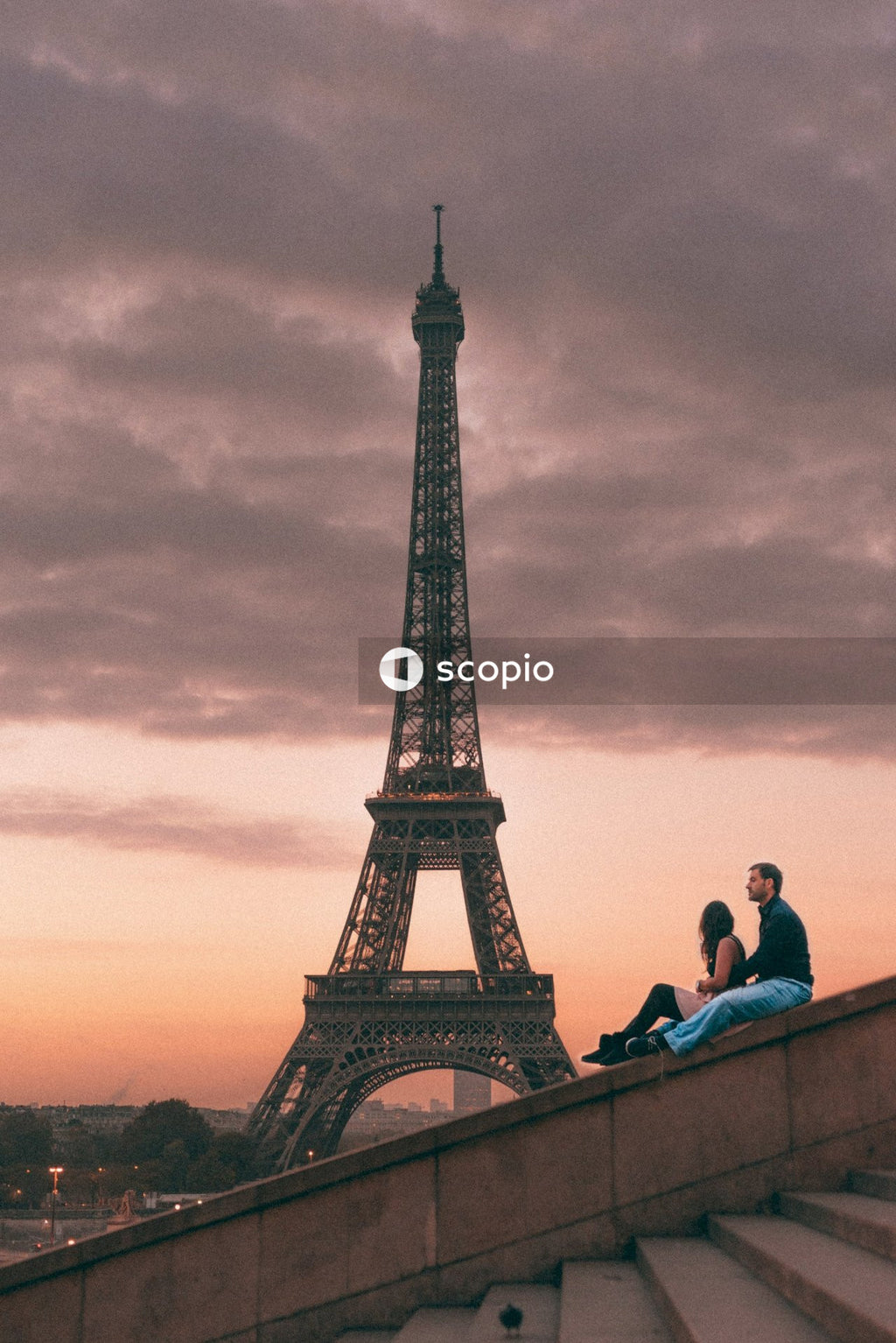 Couple sitting near eiffel tower