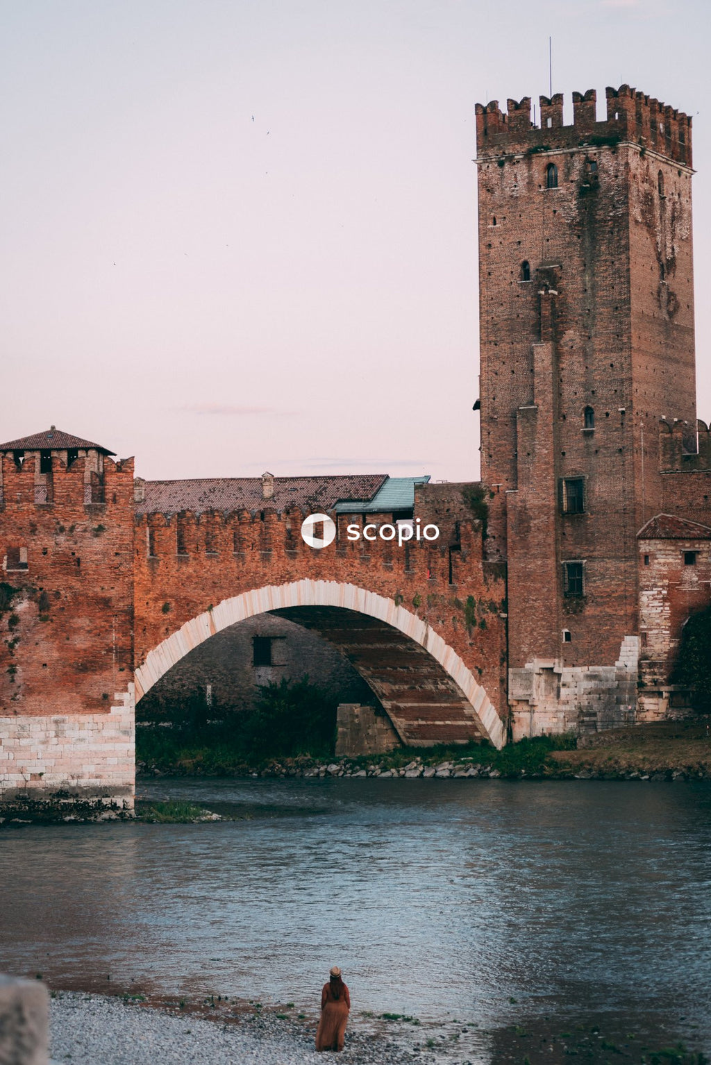 Brown brick bridge over river